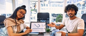 Marketing strategists showing metrics