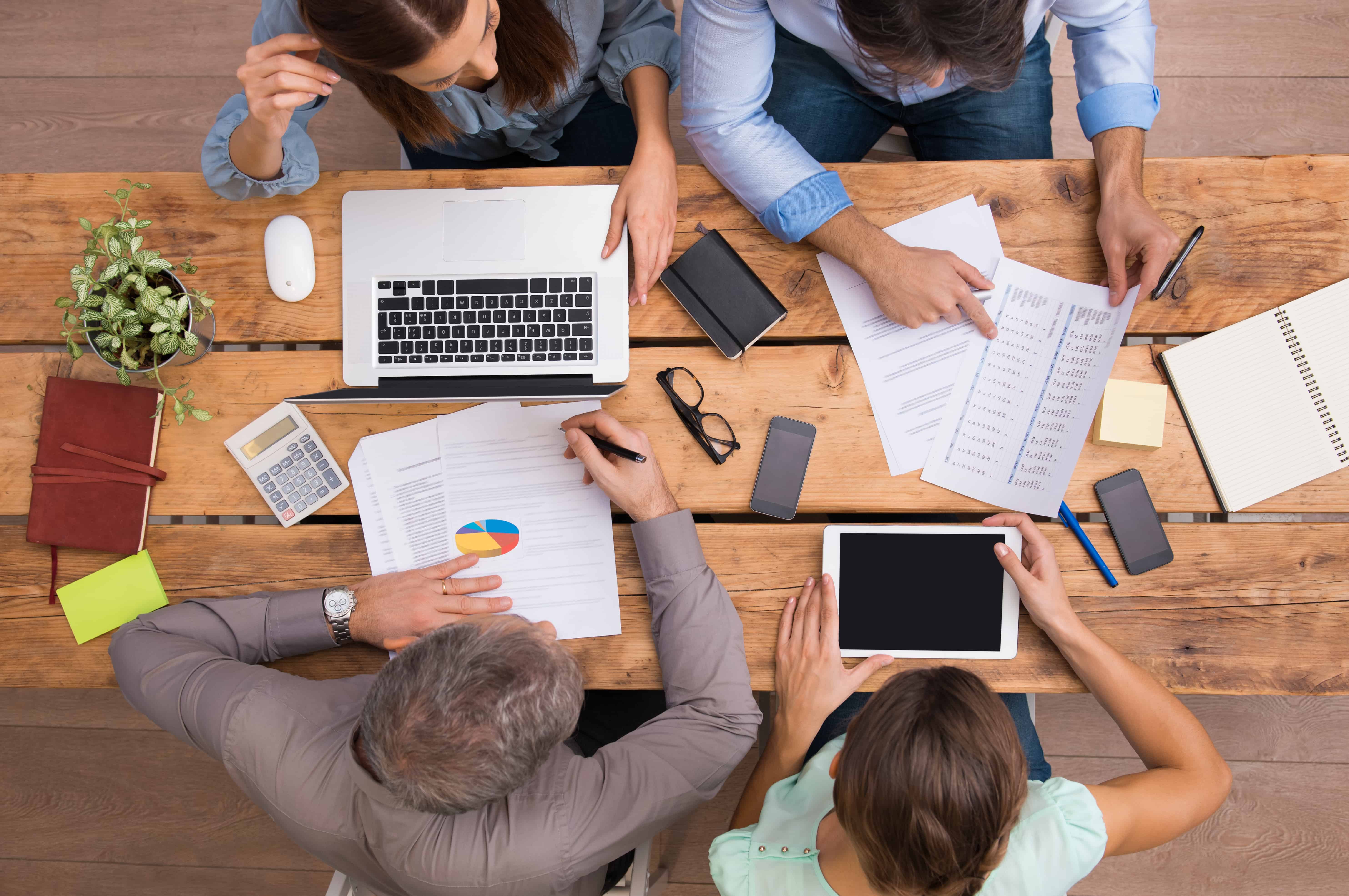 business-people-working-on-desk-PBNX795 (1)