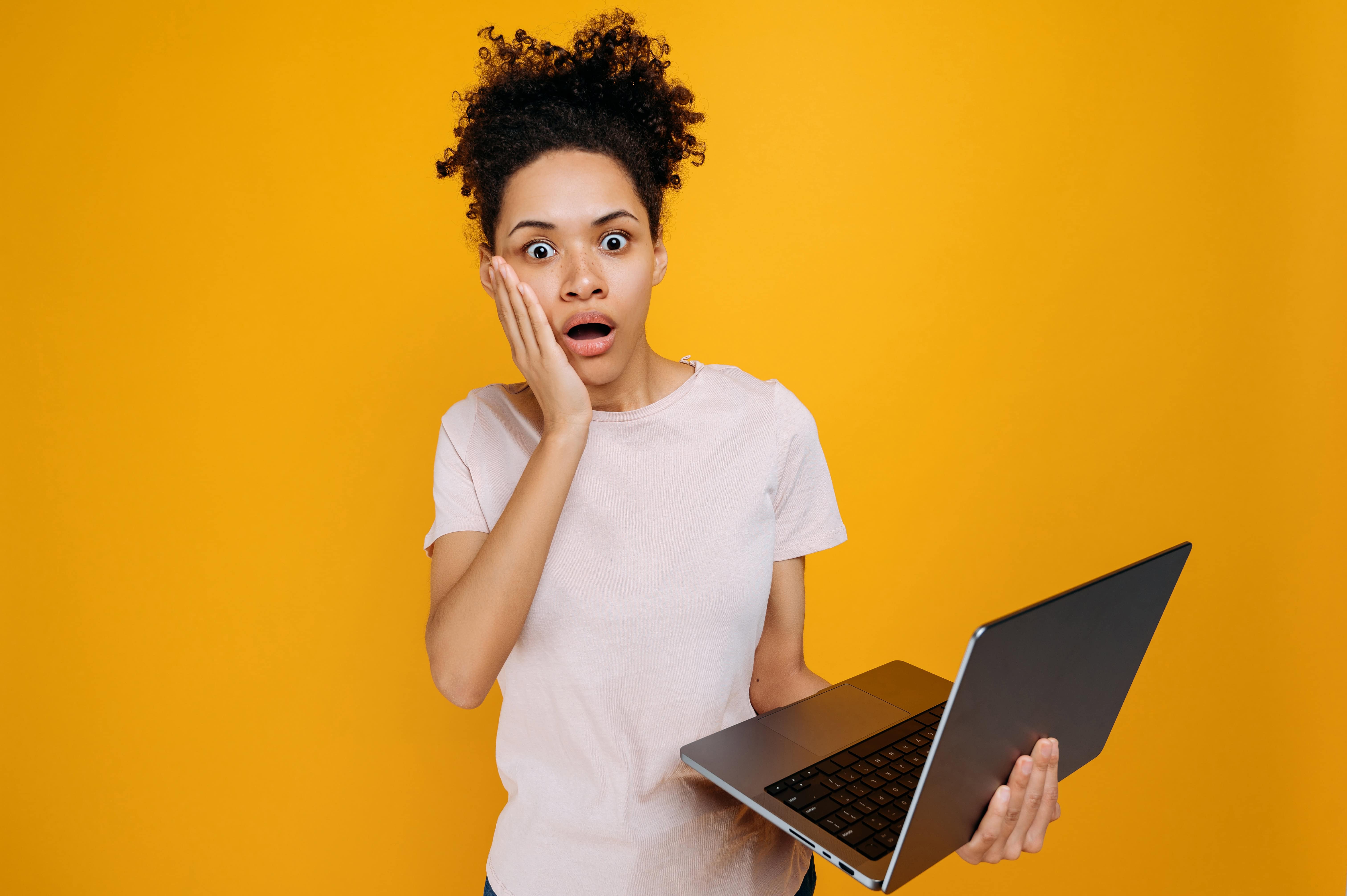 shocked-african-american-young-woman-with-curly-ha-2023-11-27-05-14-32-utc (1)